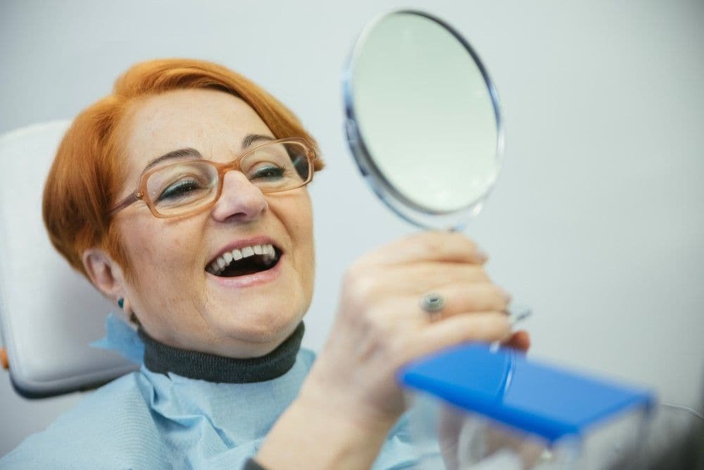 Happy dental patient having dental bridge procedure in Long Beach, CA
